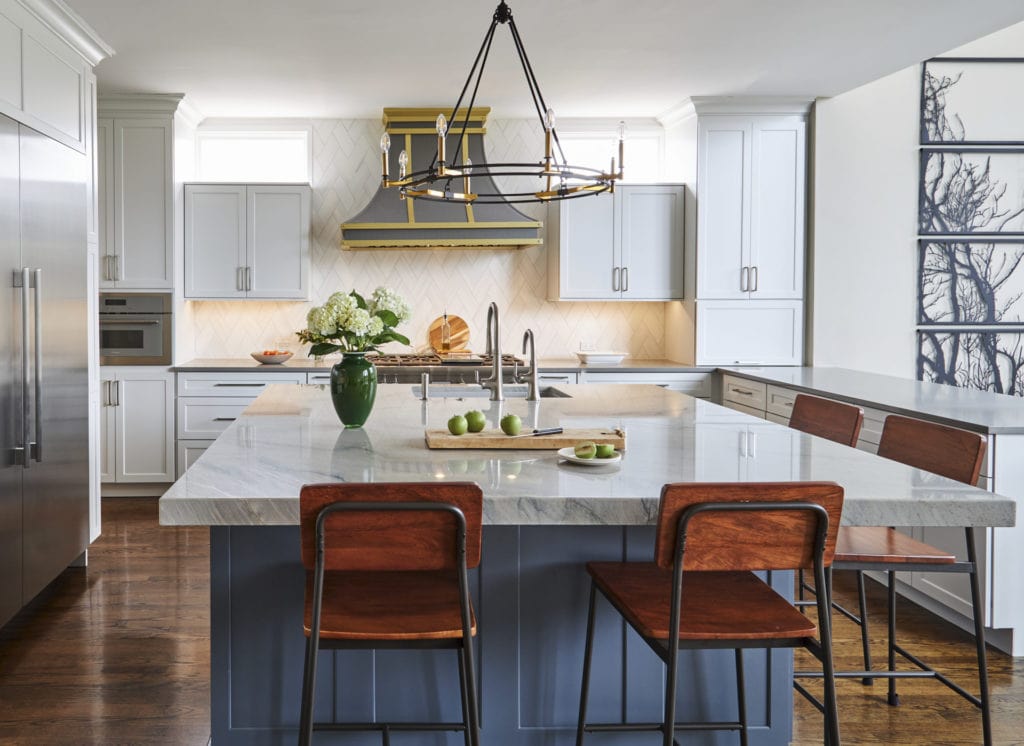 Kitchen remodel with white cabinetry and orange upholstered stools