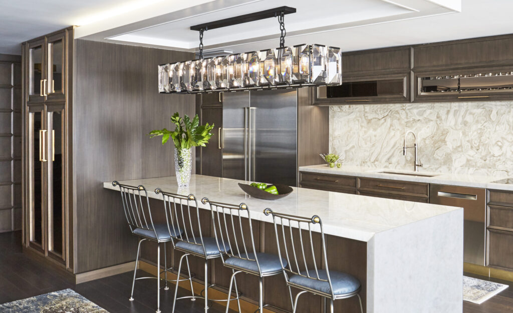 Kitchen remodel with dark wood cabinetry and modern pendant lighting over island