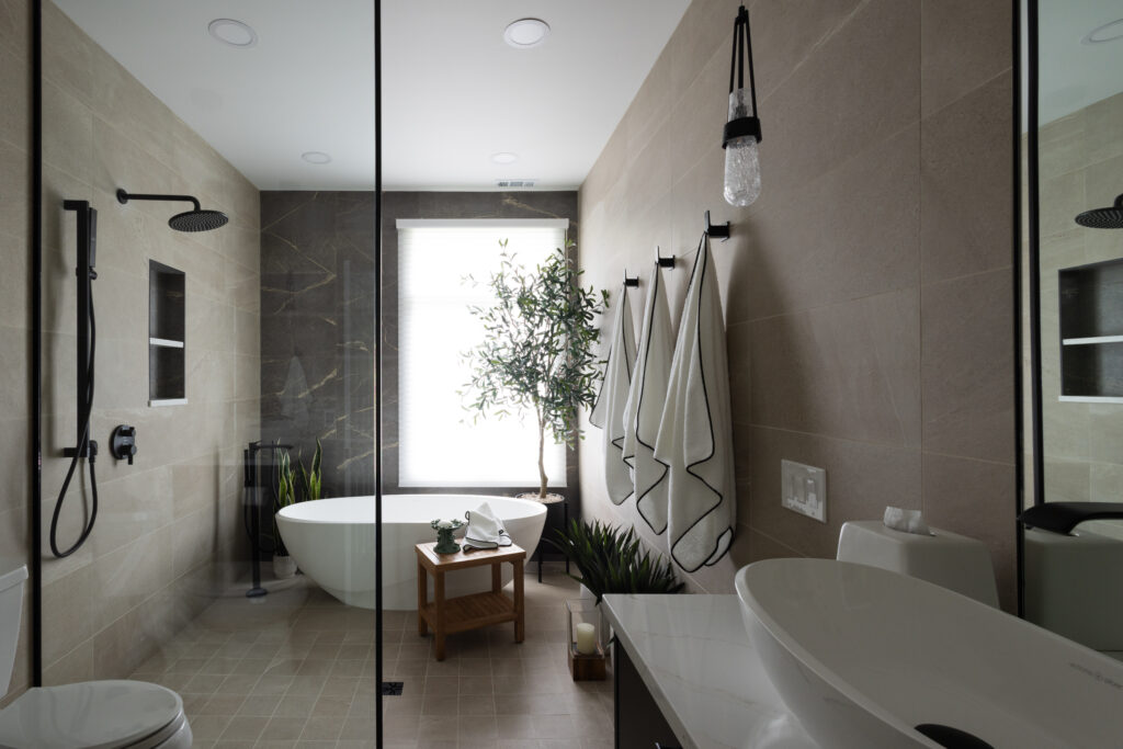 Bathroom remodel with freestanding tub and dark tile accent wall