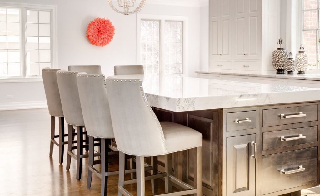 Winnetka kitchen remodel with white island and upholstered counter stools