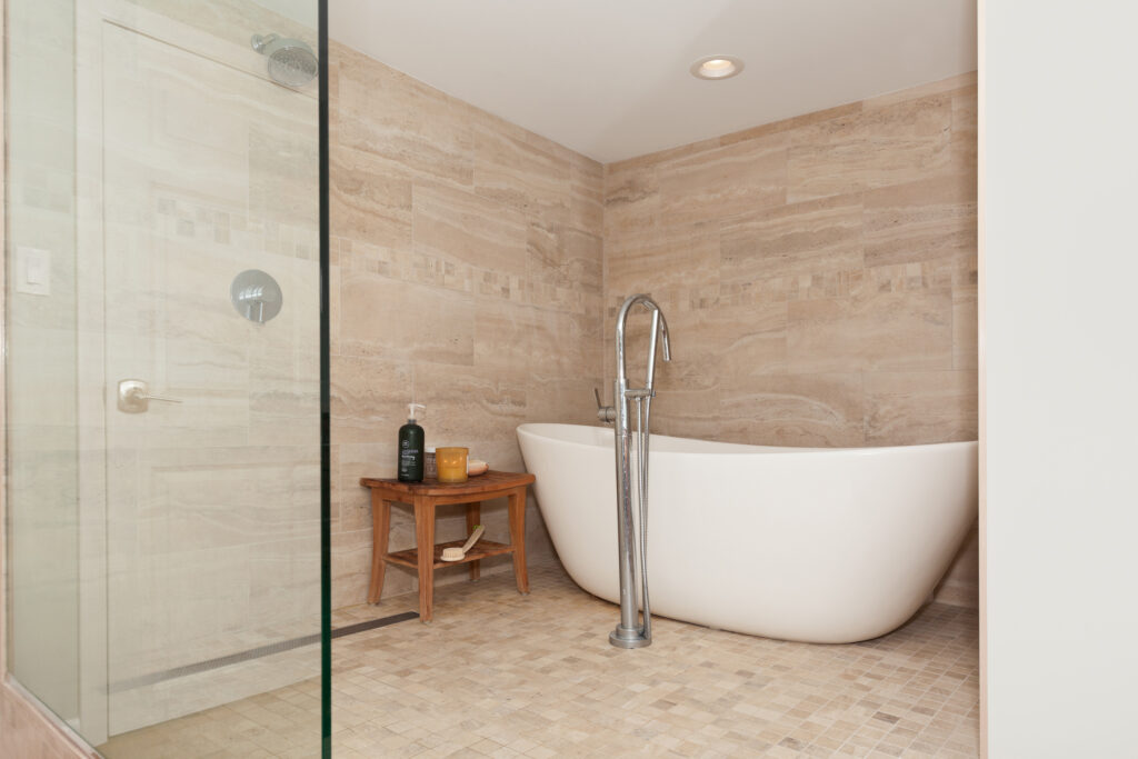 Bathroom remodel with glass-enclosed walk-in shower and freestanding soaking tub